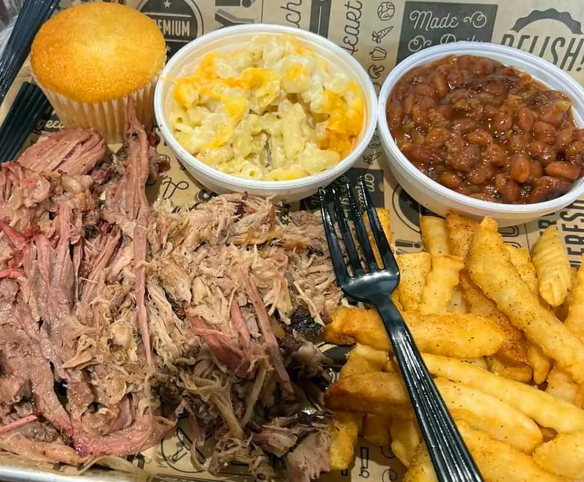 Pulled pork with three sides and a corn muffin.