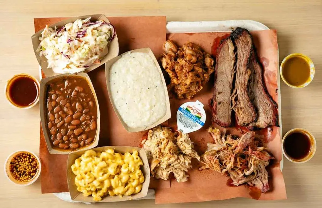 Tray of meats, sides, and sauces offered by Moohogz.