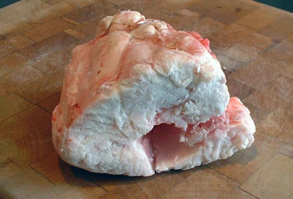 Chunk of beef suet on cutting board.