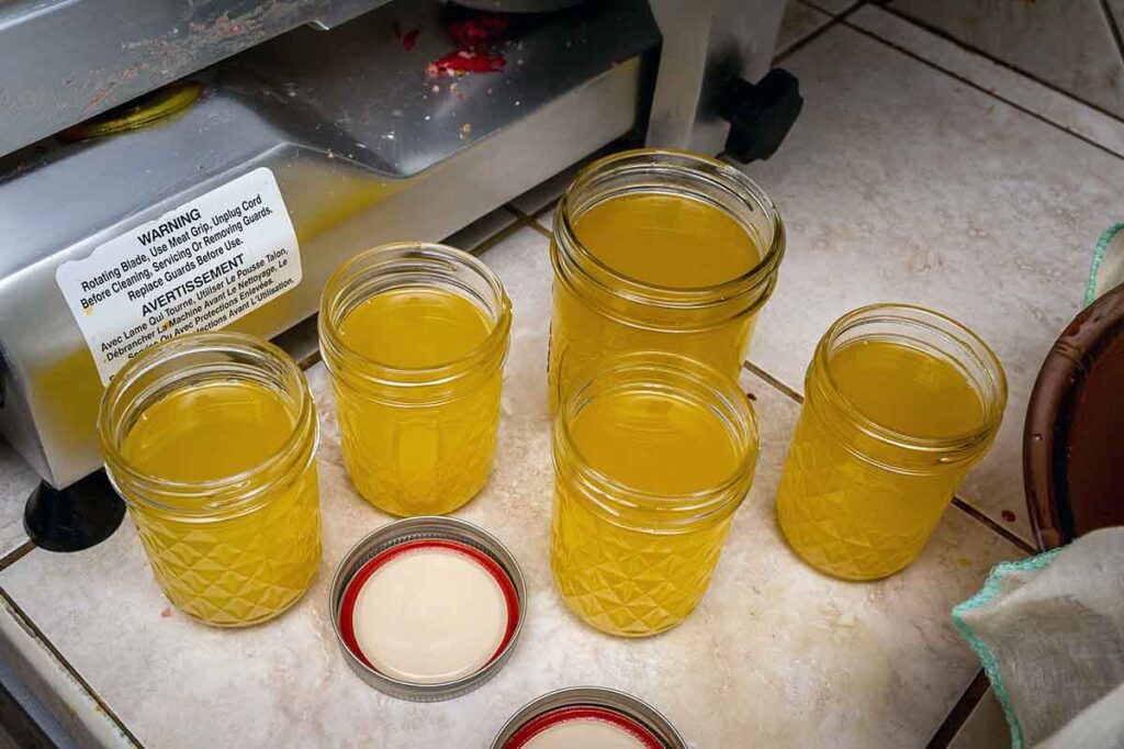 Rendered liquid tallow in mason jars on counter.