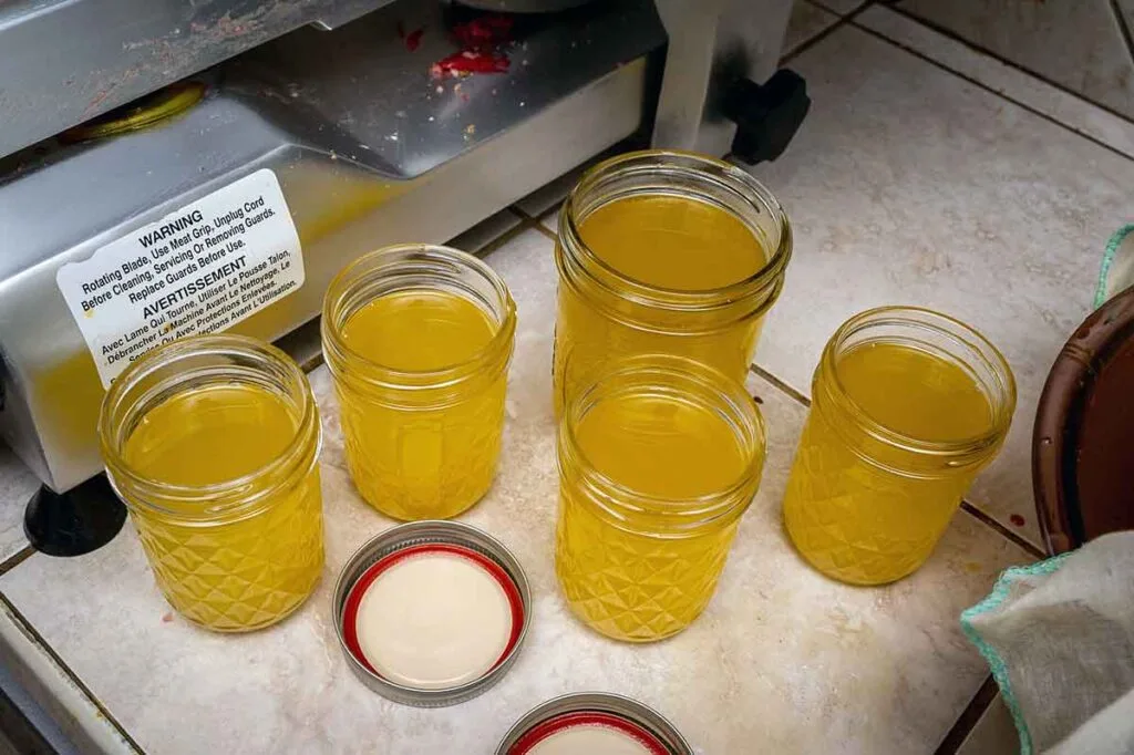 Rendered liquid tallow in mason jars on counter.