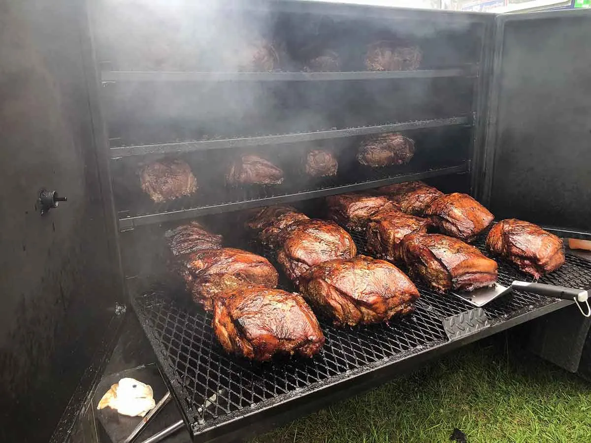 Smoker full of smoked pork butts.