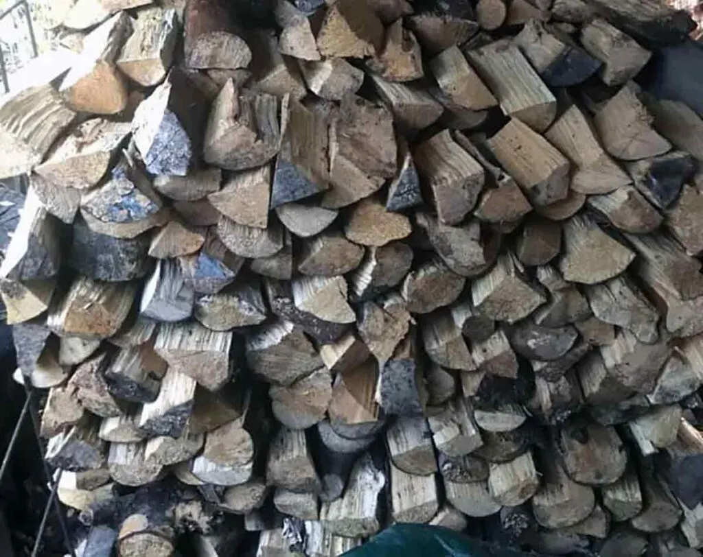 Stacked alder wood splits for sale.