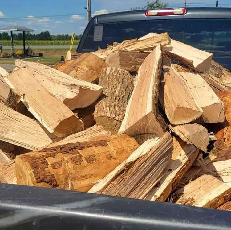 Truck bed full of split cherry firewood.