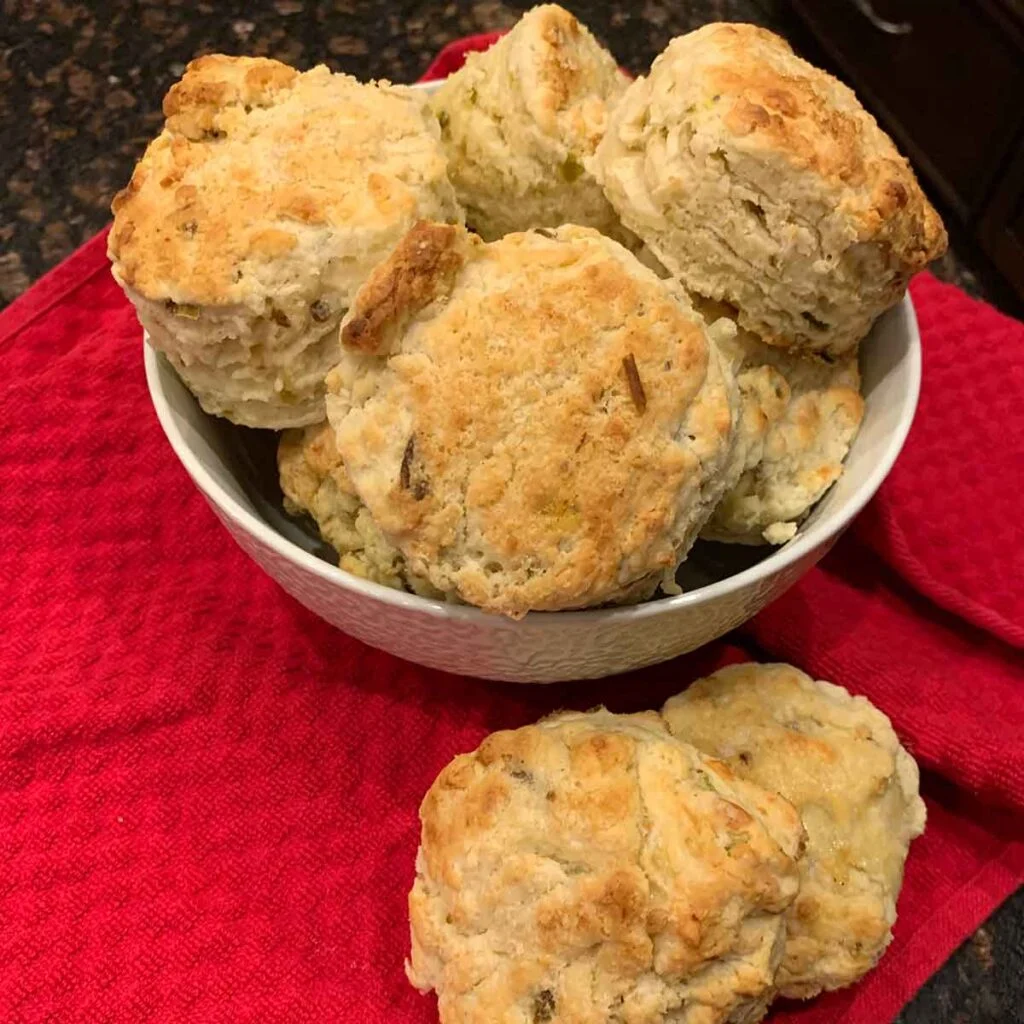 Hatch Chile Cheese Biscuits in bowl sitting on red hand towel.