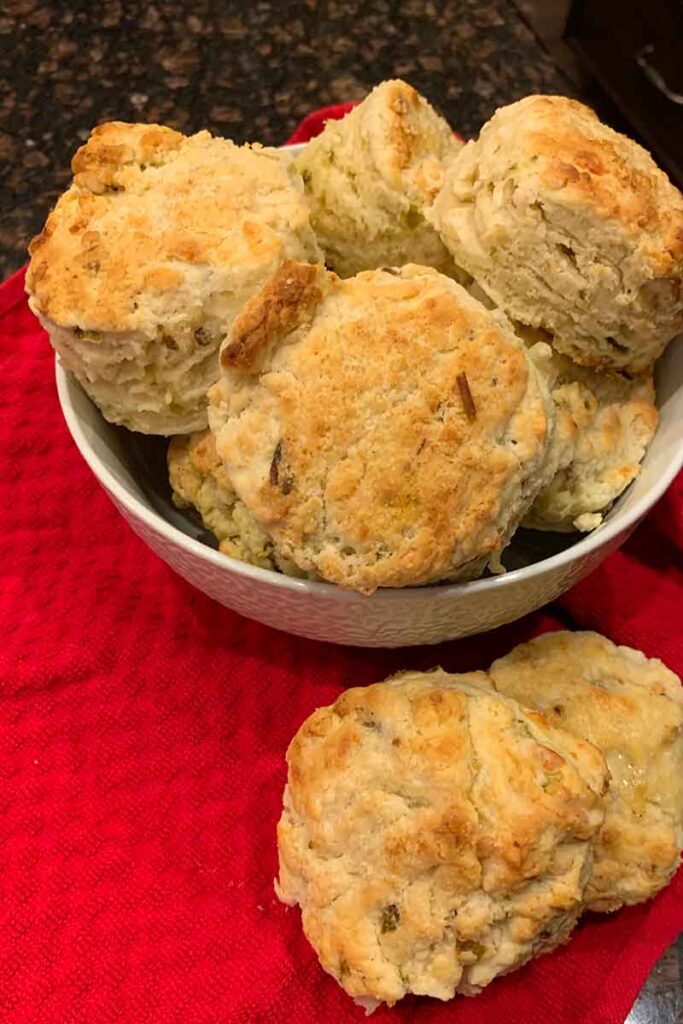 Hatch Chile Cheese Biscuits in bowl sitting on red hand towel.