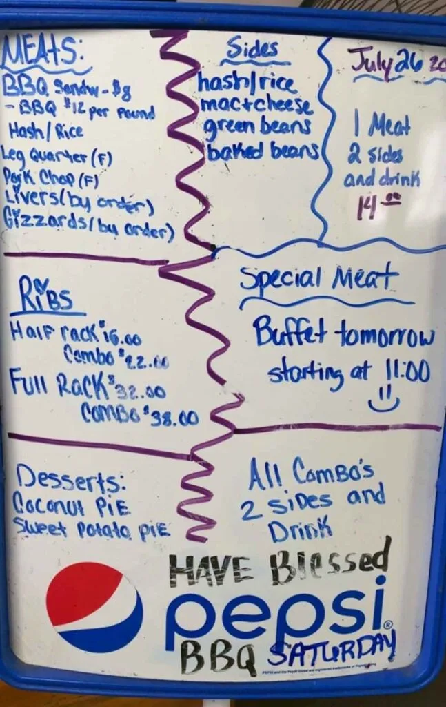 Handwritten menu board listing hash and rice, ribs, sides, and house desserts.