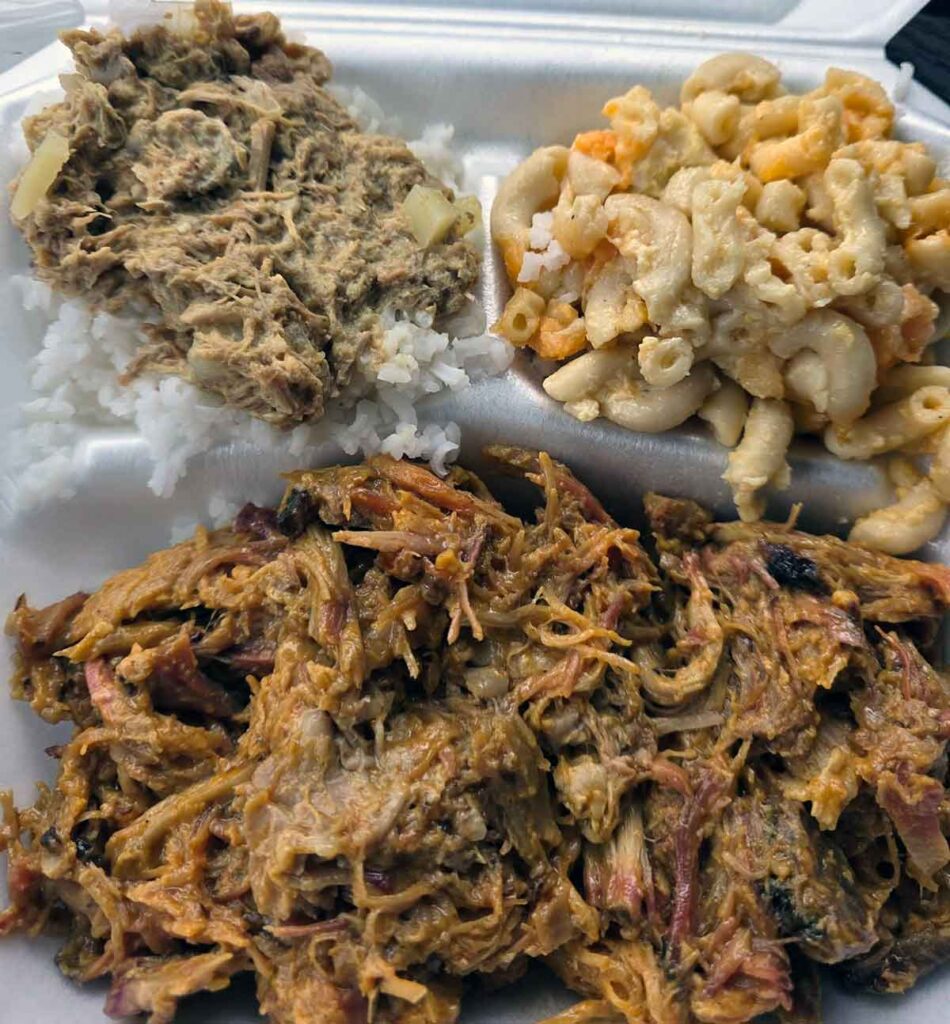 Plate with pulled pork, hash over rice, and mac and cheese.