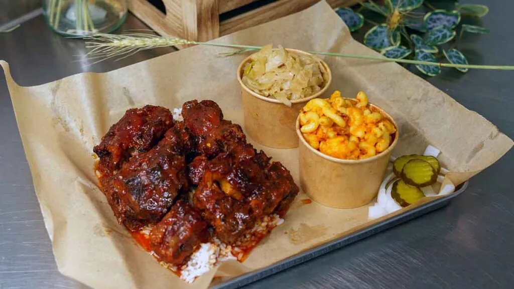Braised BBQ oxtails over rice with slaw and Mac and cheese.