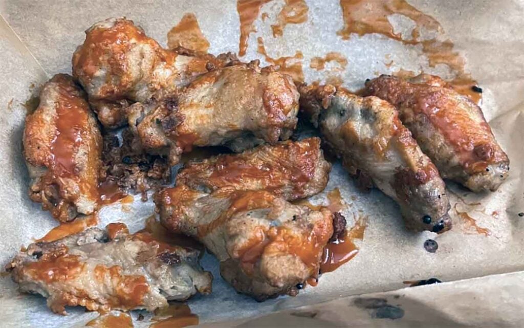 Sauced wings turned soggy from sitting too long, a troubleshooting example.