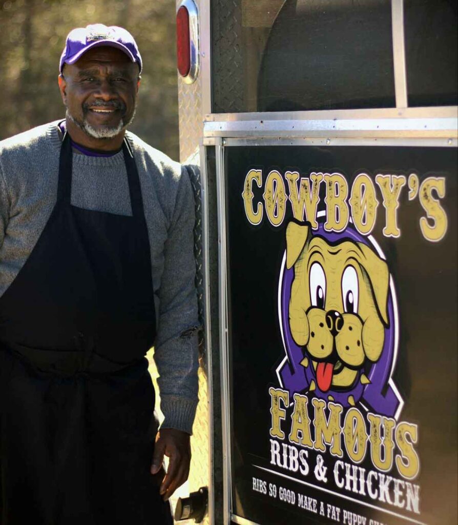 Robert "Cowboy" Gordon, leaning against his food truck.