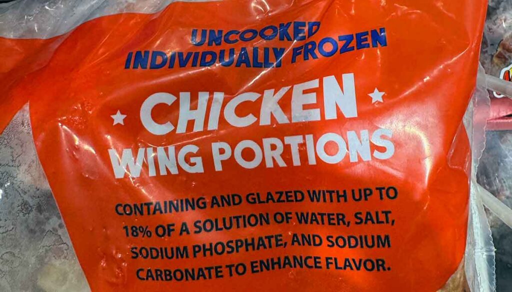 Frozen wing bag showing “individually frozen,” “glazed,” and “up to 18% solution,” highlighting ice glaze and added solution.