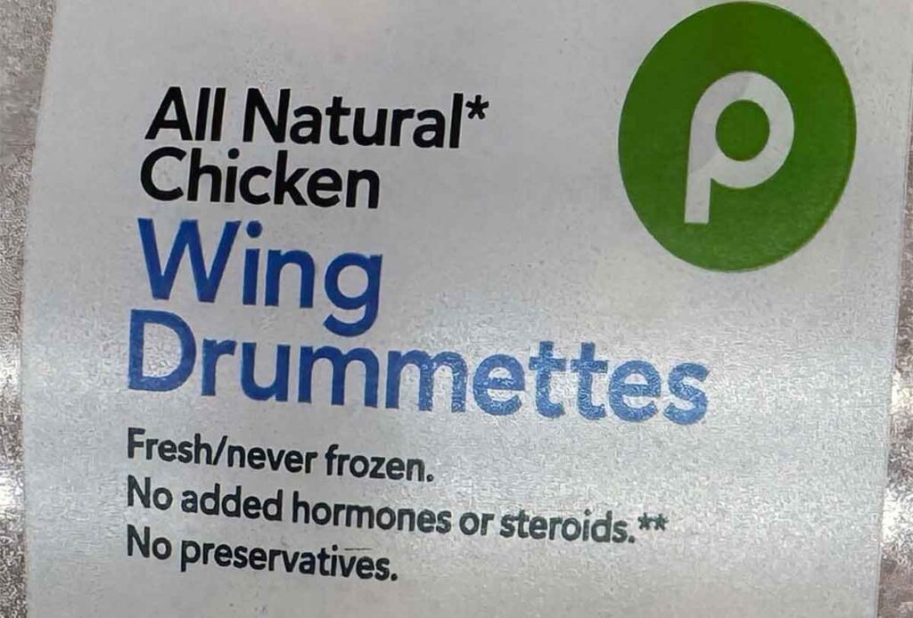 Chicken wing label showing “fresh/never frozen” and “no preservatives,” a common fresh-case claim set.