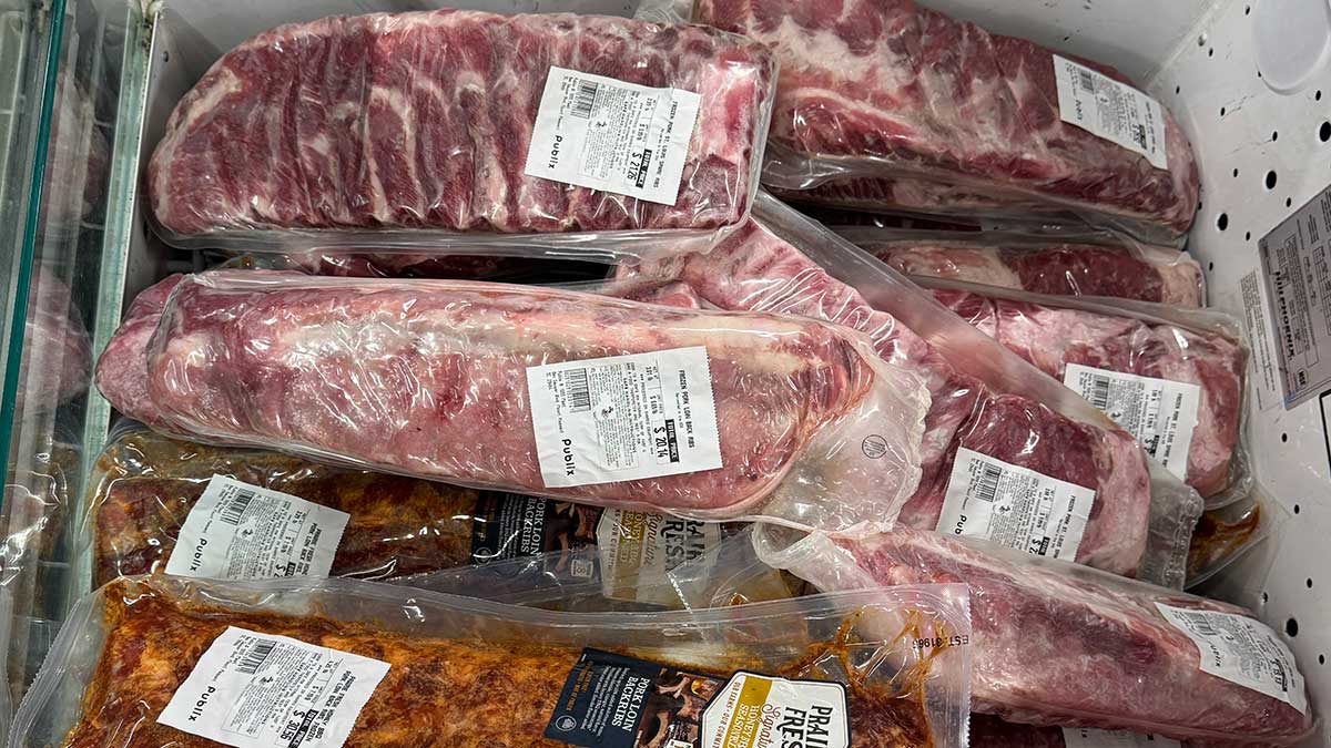 Grocery meat case with raw and seasoned rib packages, showing why rib buyers need to check cuts, labels, and package sizes.