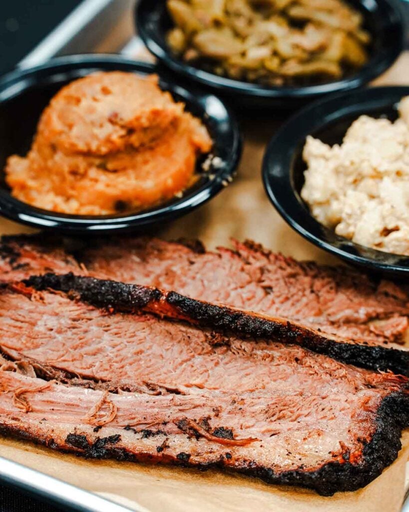 Slices of brisket with sides.
