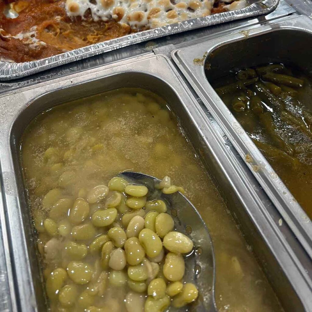 Butter beans among other sides on buffet.