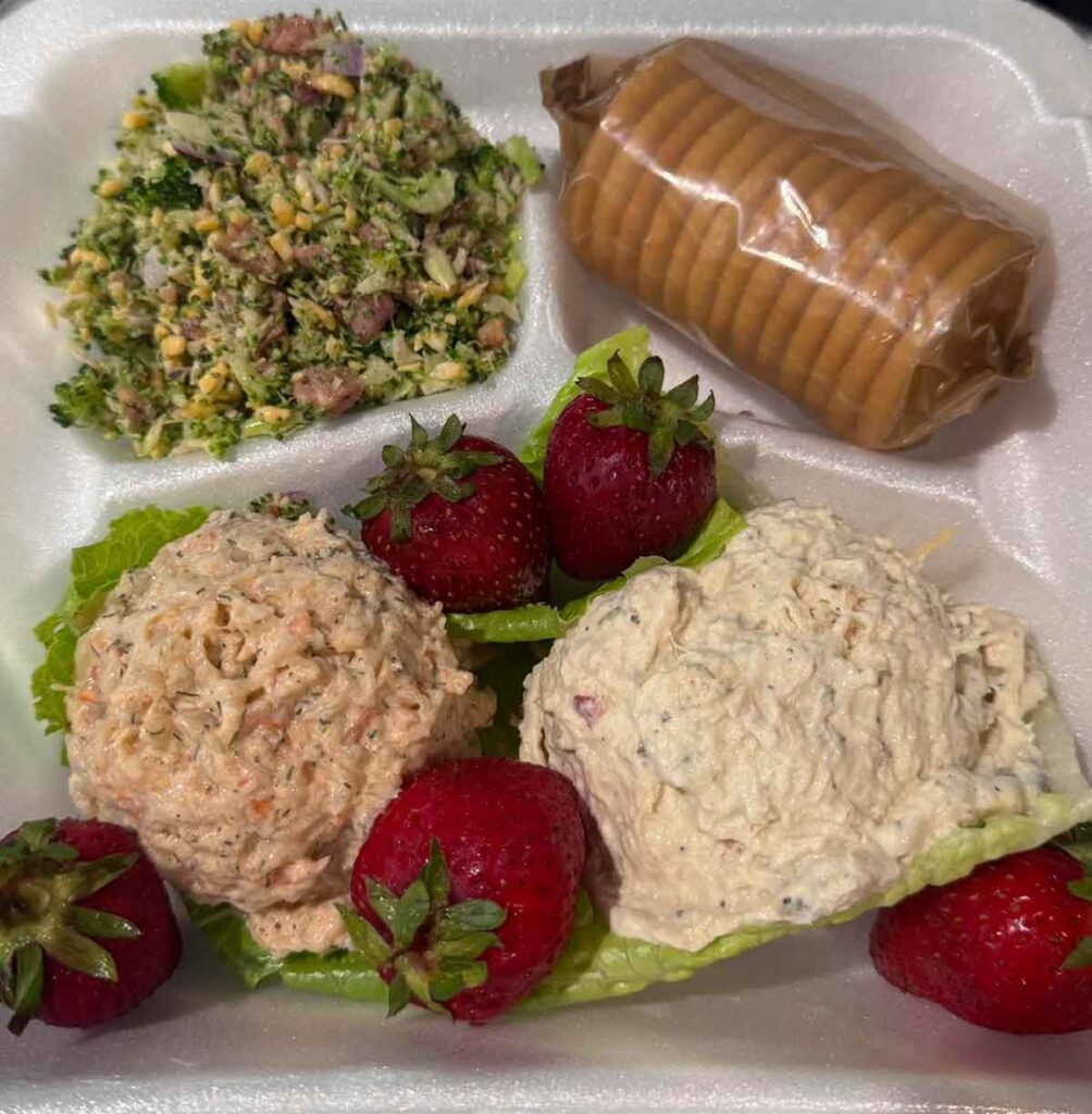Cold plate sampler with chicken, shrimp and broccoli salads with Ritz crackers and strawberries.