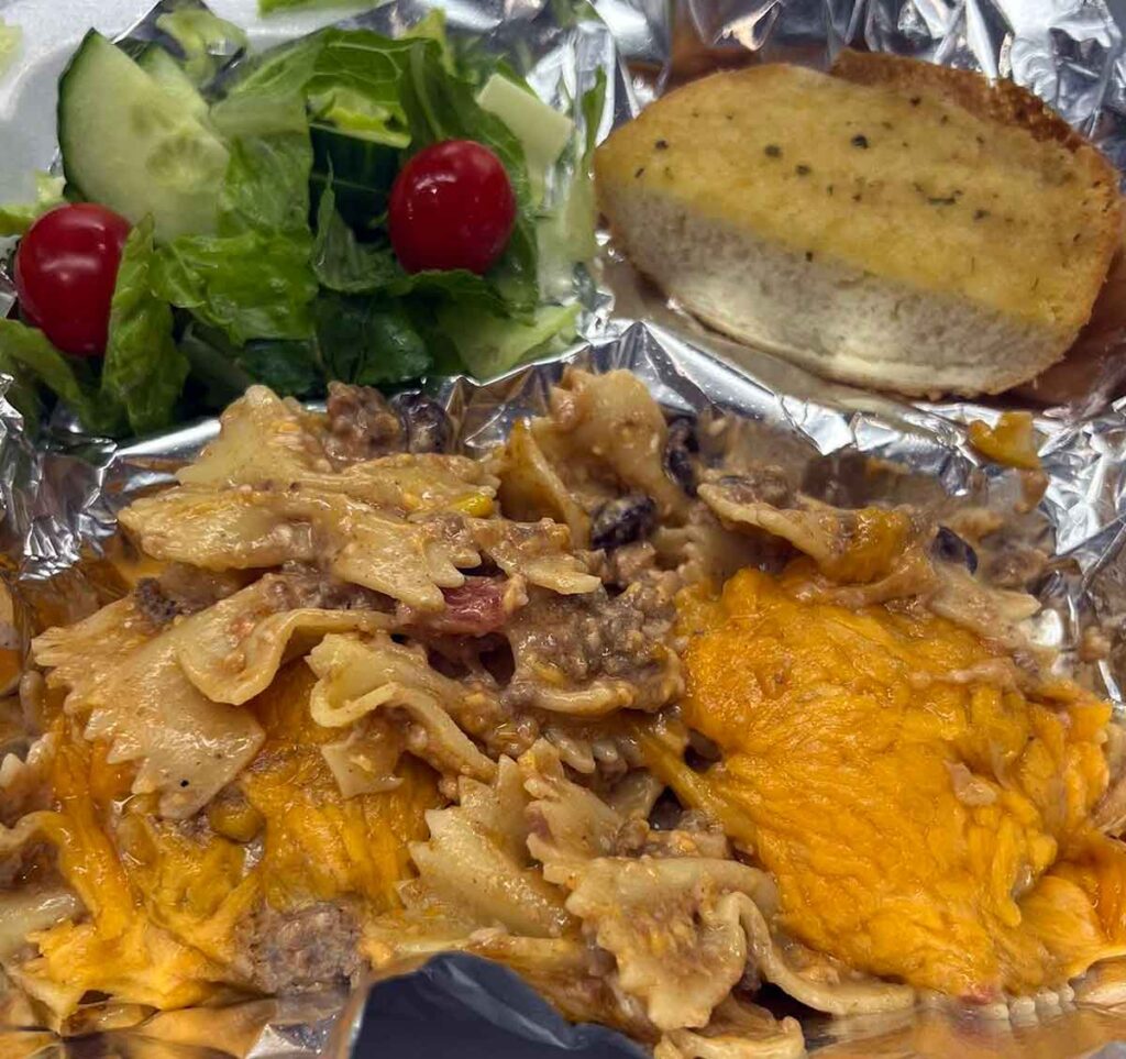 Cowboy pasta with side salad and garlic bread.