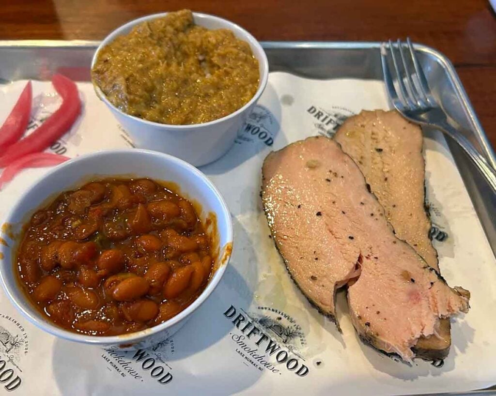 Hash and baked beans with slices of smoked meat.