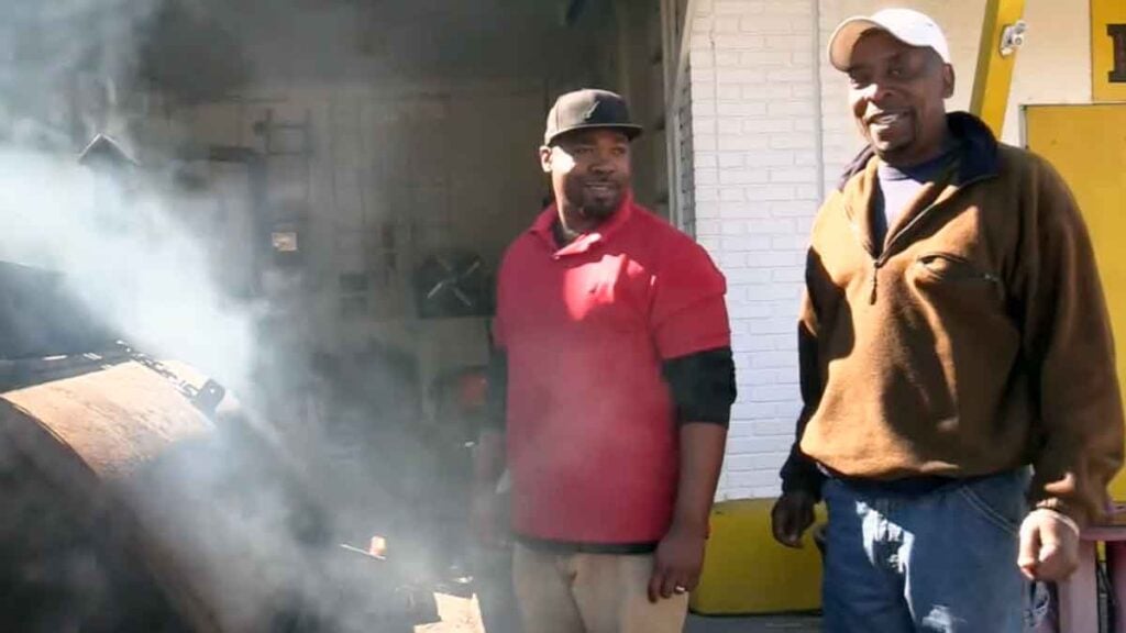 Horace Adger and his father Milford by the smoker.