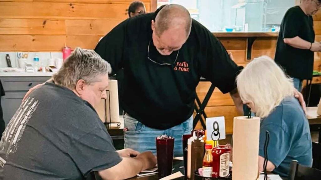 Praying with guests before eating.