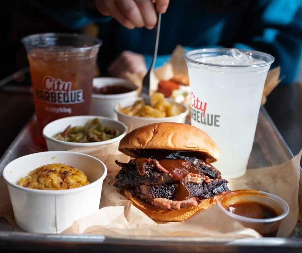 Brisket sandwich tray with sides and drinks.