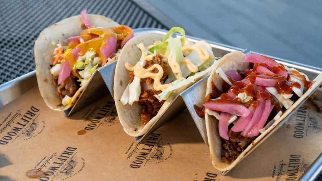 A trio of tacos from Driftwood Smokehouse.