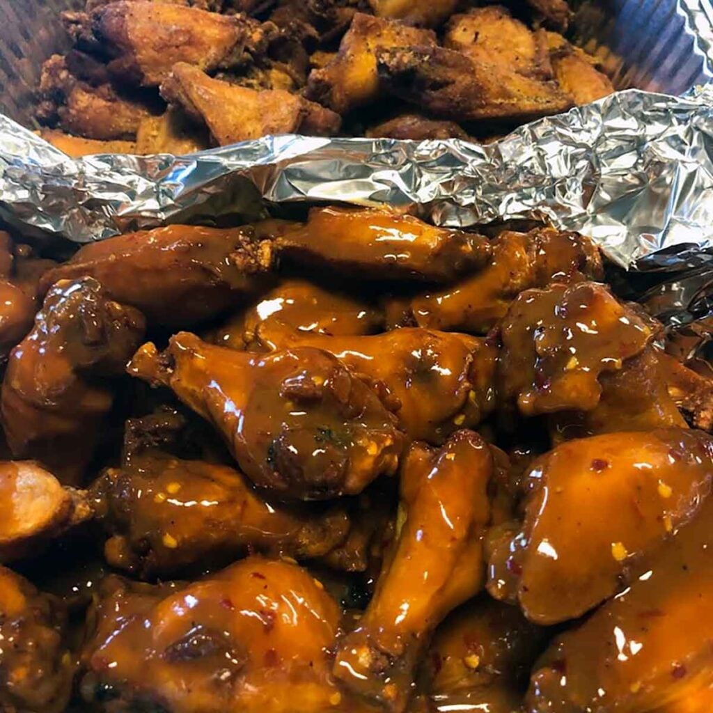 Two flavors of wings in a tray.