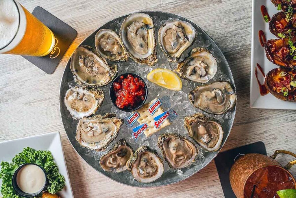 Overhead view of oysters on the half shell in a bed of ice.